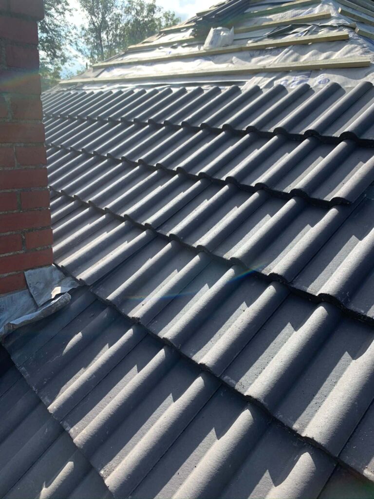 This is a photo of a re-roof where the works are in progress, the felt, batten and a few rows of tiles have been installed by Northampton Roofing ServicesThis is a photo of newly installed fascia boards by Northampton Roofing Services