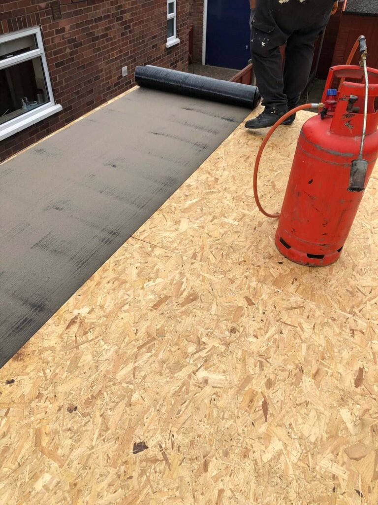 This is a photo of the final layer of a flat roof being installed by Northampton Roofing Services