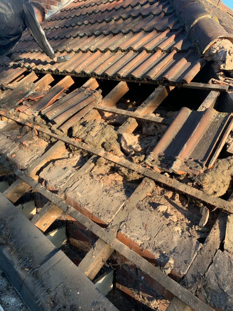 This is a photo of a hipped roof which is being stripped and replaced. It is currently part stripped and in very poor condition by Northampton Roofing Services