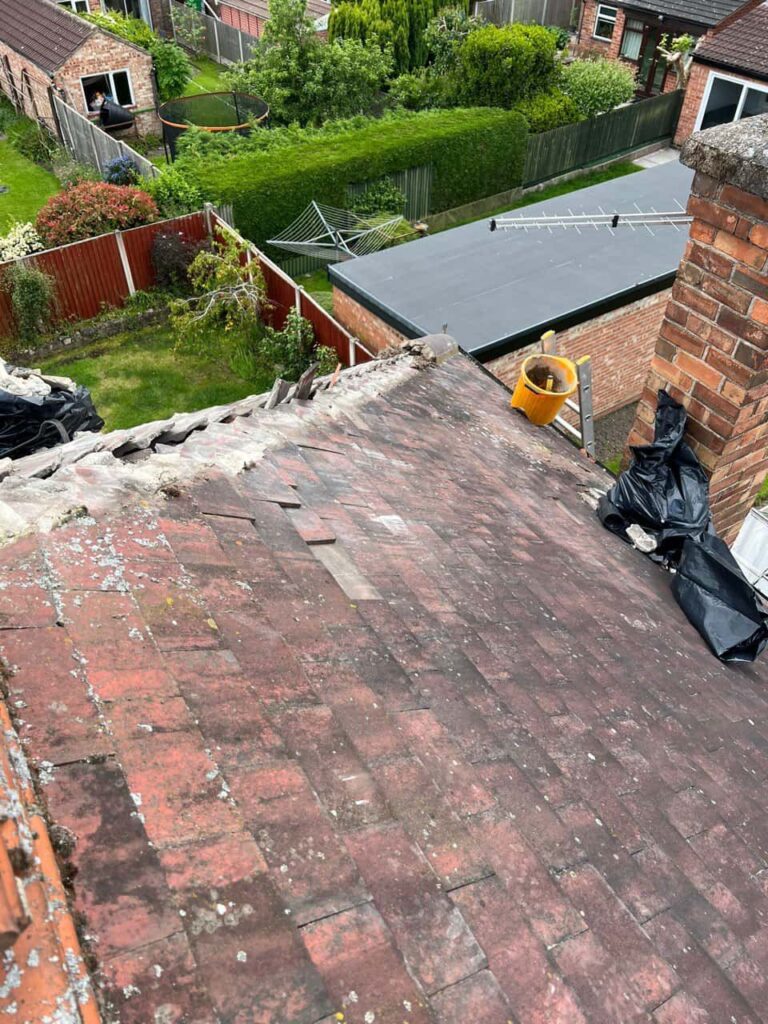 This is a photo of a hip roof where the verge (bonnet) tiles are going to be replaced. They are currently missing by Northampton Roofing Services